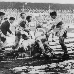 An Oldham player receives some close attention from the St. Helens defence - Feb 19th 1955.