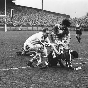 Vince Karalius and Jan Prinsloo haul down Alan Davies - Dec 27th 1958.