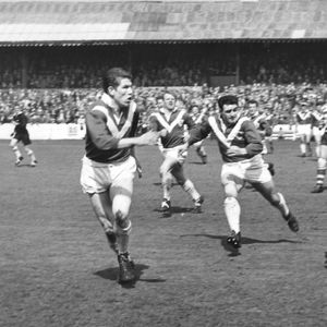 Johnny Noon release a pass as the Swinton cover closes in - April 28th 1962.