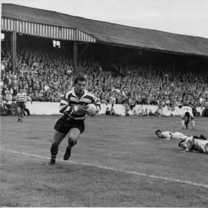 Leaving several defenders in his wake and with Alan Kellett in support, Alan Davies scores one of his four tries v …