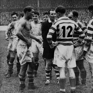 The referee sorts out a disagreement between a shirtless Doug Phillips and the Wigan forwards - Oct 15th 1946.