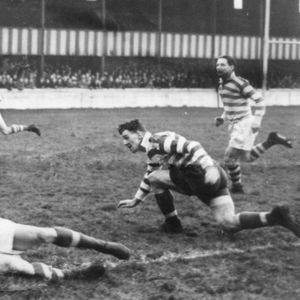 Alan Davies is tackled by Jack Broome watched by Harry Ogden and George Roughley with a young Brian McTigue, making his …