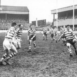 Derek Turner puts in a kick watched by his team-mates as the Wigan defence closes in - March 30th 1957.