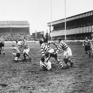 Brian McTigue snaps up a loose ball - April 5th 1958.