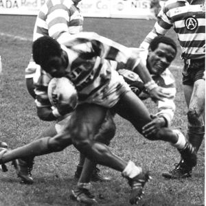 Henderson Gill falls to a tackle from Pat Mitchell - April 8th 1985