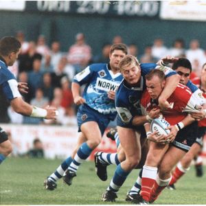 Chris McKinney is well held at Boundary Park by Simon Haughton and Harrison Hansen v Wigan - Aug 22nd 1997.