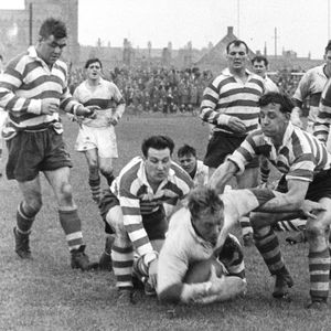 Frank Pitchford and Jack Keith tackle the Workington forward Norman Herbert - Sep 28th 1957.