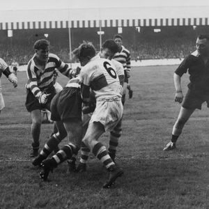 Referee, Eric Clay keeps an eye on the action as Sol Roper makes a tackle with Des McKeown standing by - Sep 2nd 1958.