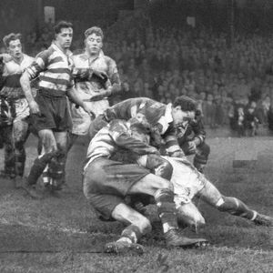 Players from both teams look on as the Oldham defence stop McDowell near the try line at Derwent Park - Dec 13th 1958.
